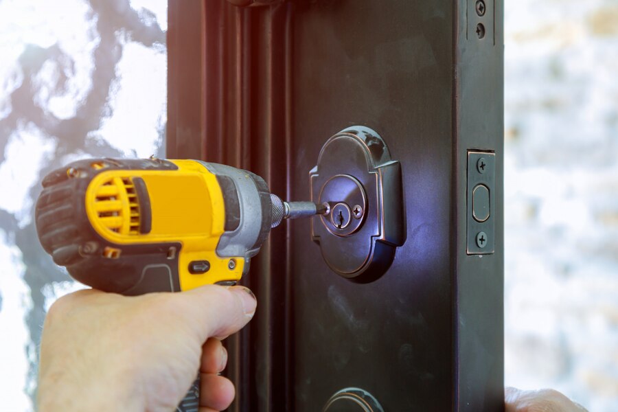 man fixing door lock