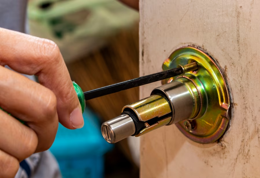 man fixing door lock